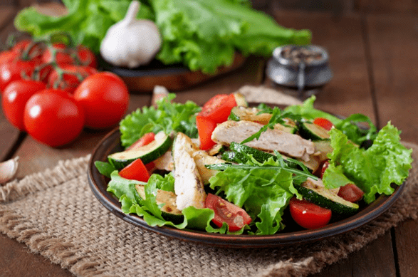 A salad made with chicken and vegetables is a great choice for a light dinner after a workout. 